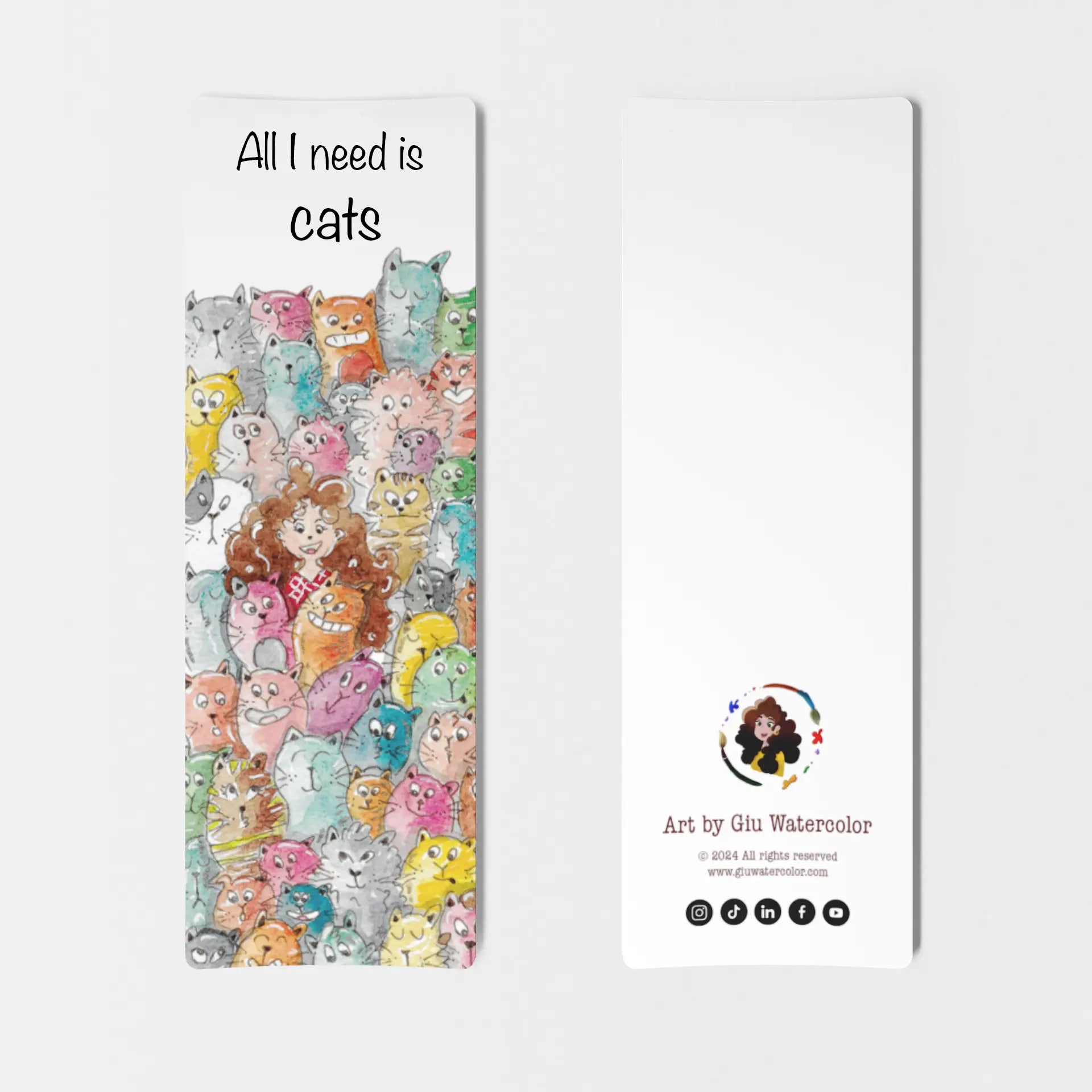 Watercolor bookmark with a girl surrounded by colorful cats and the phrase “All I need is cats” — art by Giulia Giampaolo.