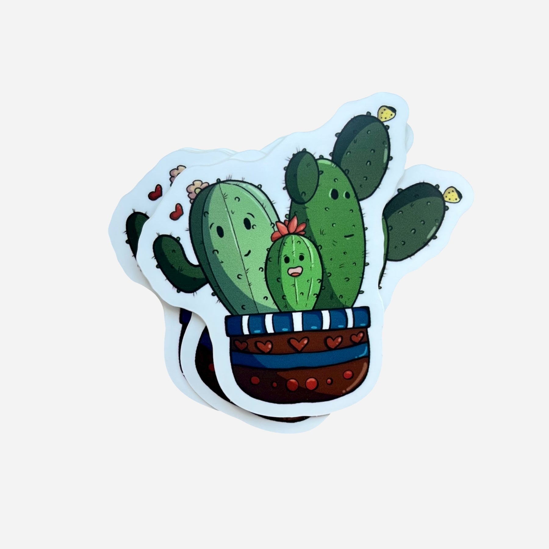 Sticker of a cartoon cactus plant with a pot on a light blue background