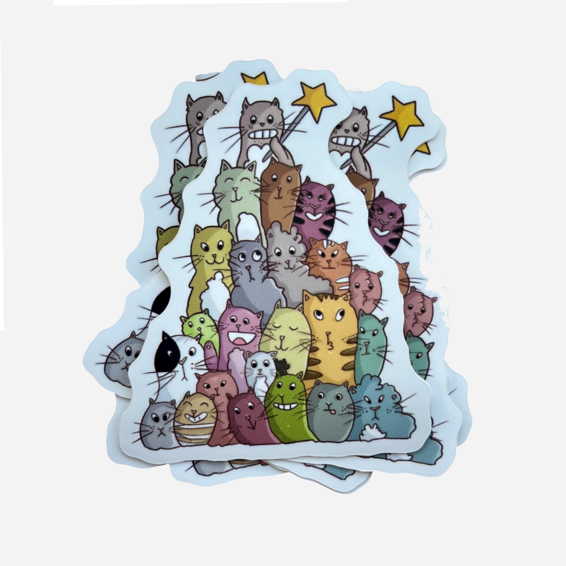 Several Catmas stickers stacked, featuring cheerful Christmas cats arranged like a festive tree, by Giulia Giampaolo.
