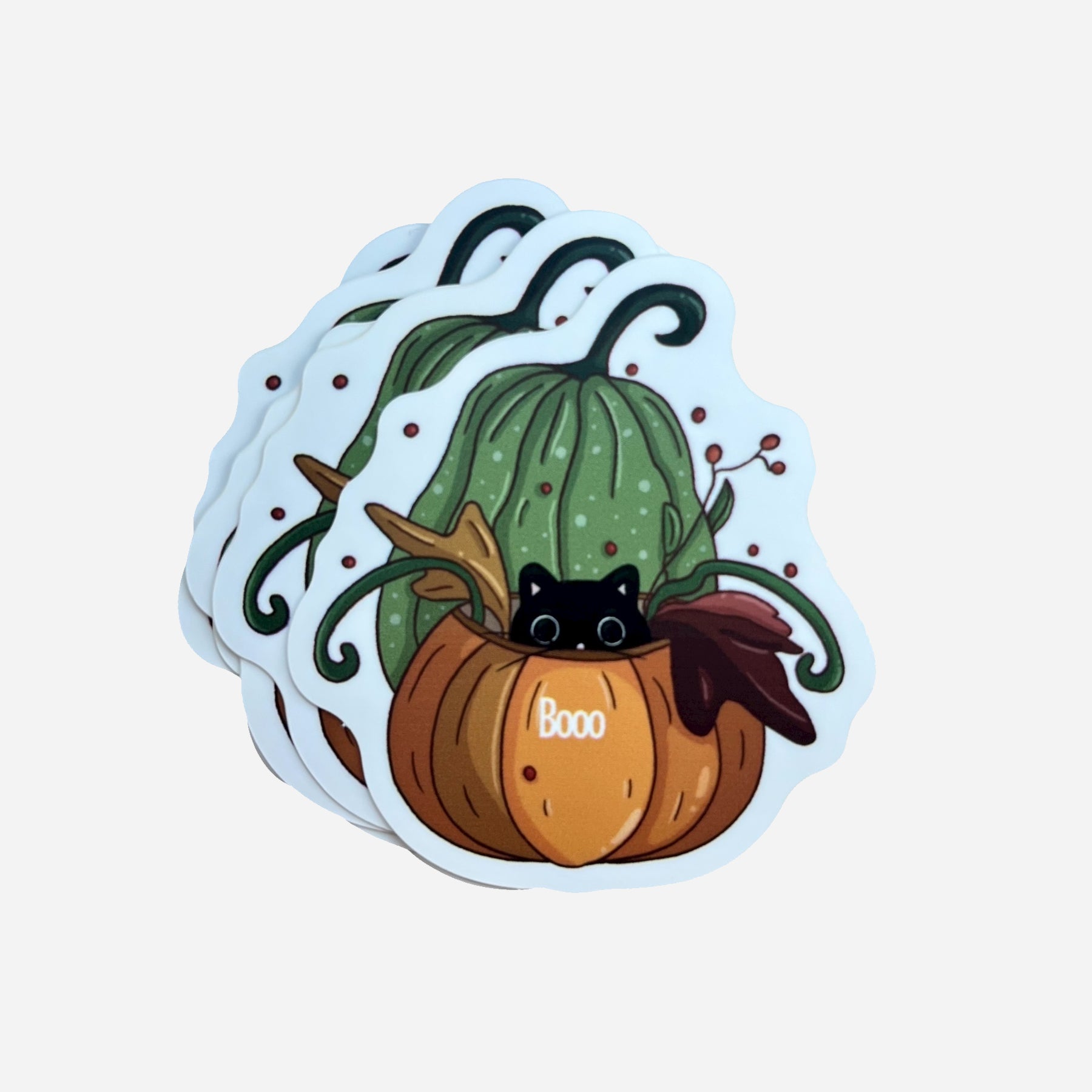 A pack of Halloween stickers featuring a cute black cat inside an orange pumpkin with green vines, illustrated by Giulia Giampaolo.